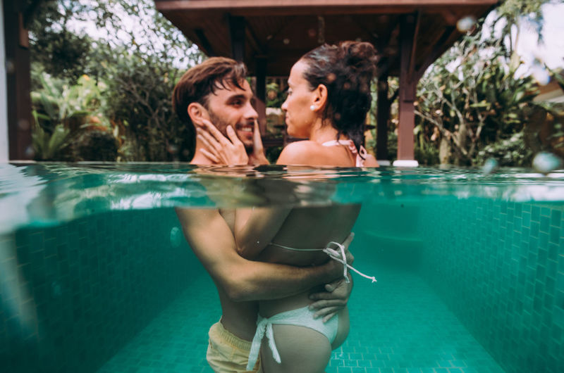 Young couple swimming in pool