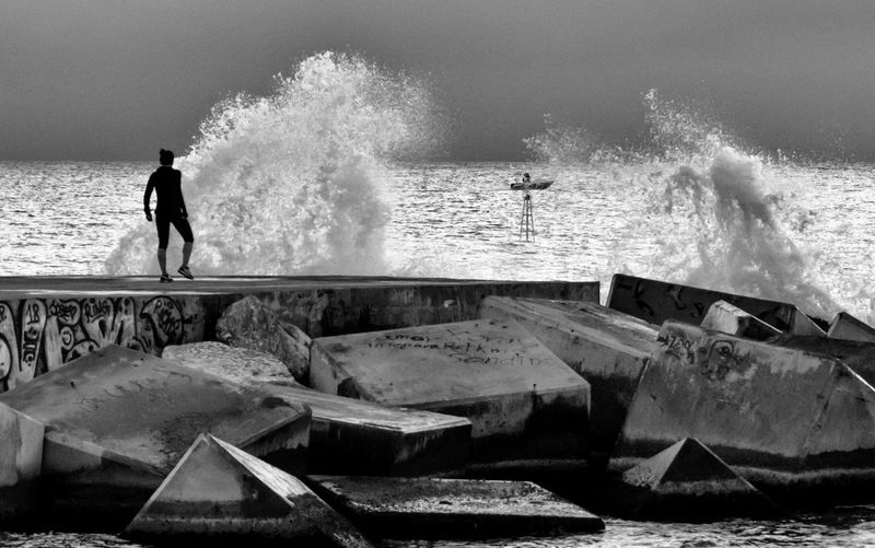 Rear view of man standing at beach