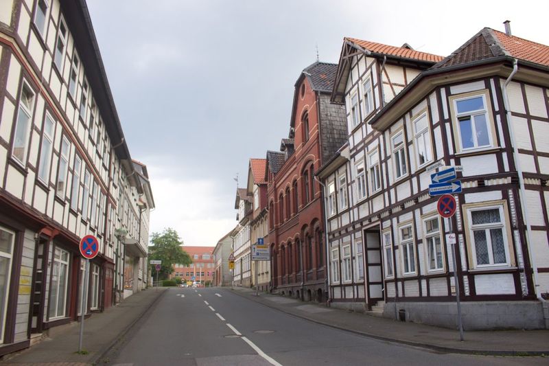 Road amidst buildings against sky