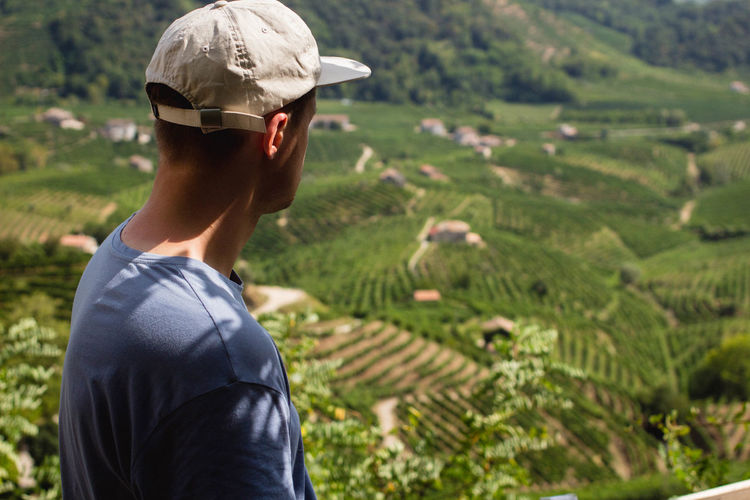 Side view of man standing against farm