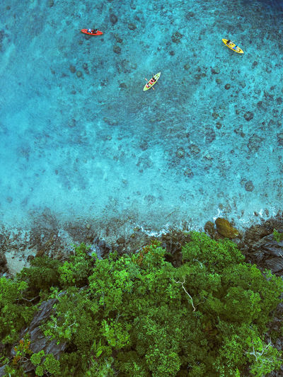 High angel view of kayaks surrounded by turquoise water