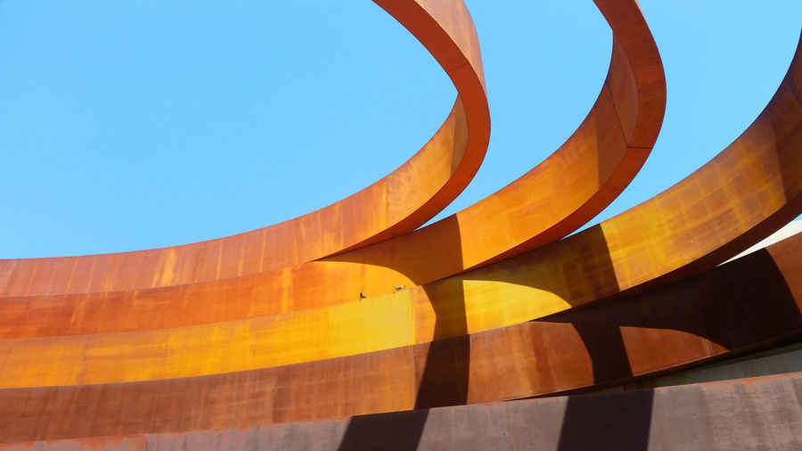 Low angle view of holon design museum building against blue sky