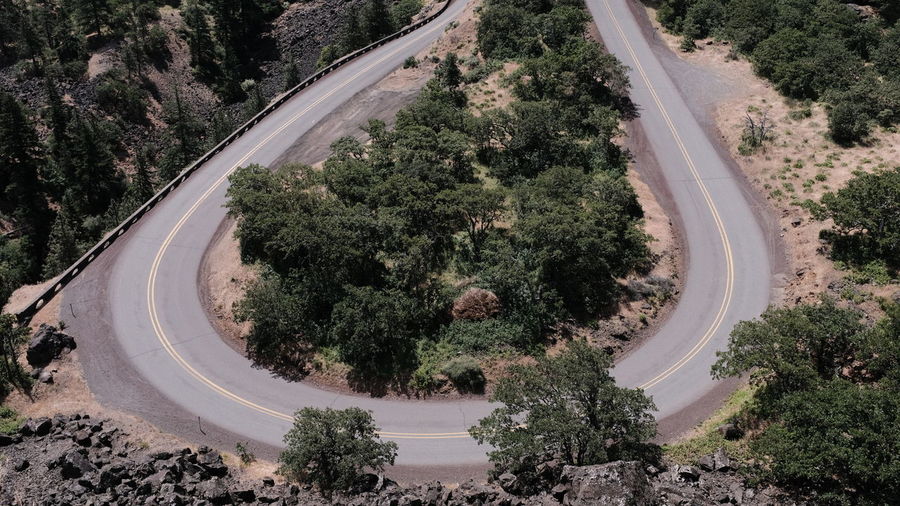 High angle view of vehicles on road amidst trees