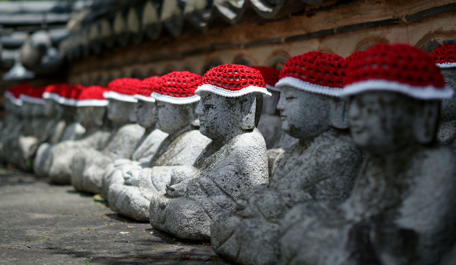 Sculptures with knit hats in row