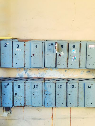 Old rusty metallic mailboxes on wall