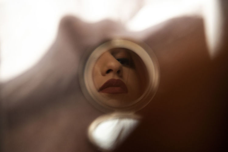 Woman reflecting in mirror