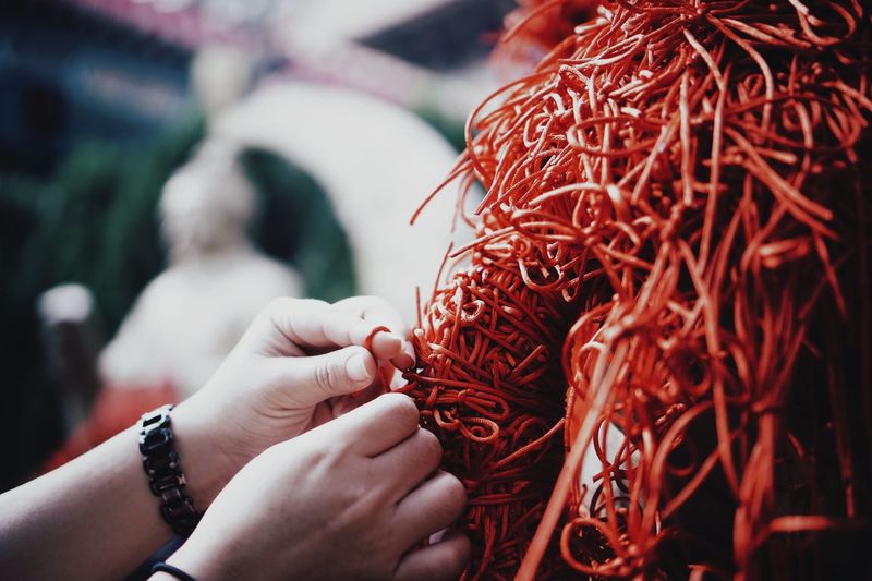 Cropped hand tying string