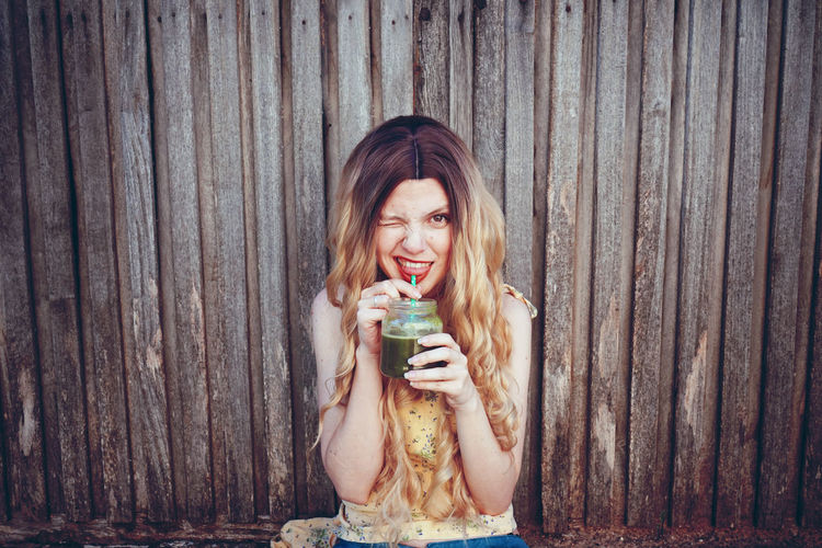 Portrait of beautiful woman having smoothie