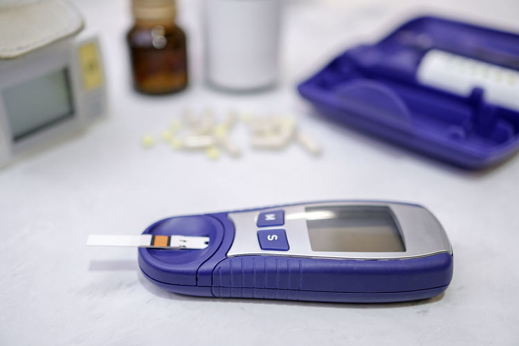 Close-up of blood sugar test equipment on table