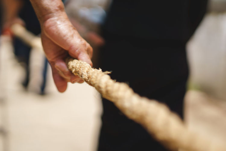 Close-up of hand holding rope