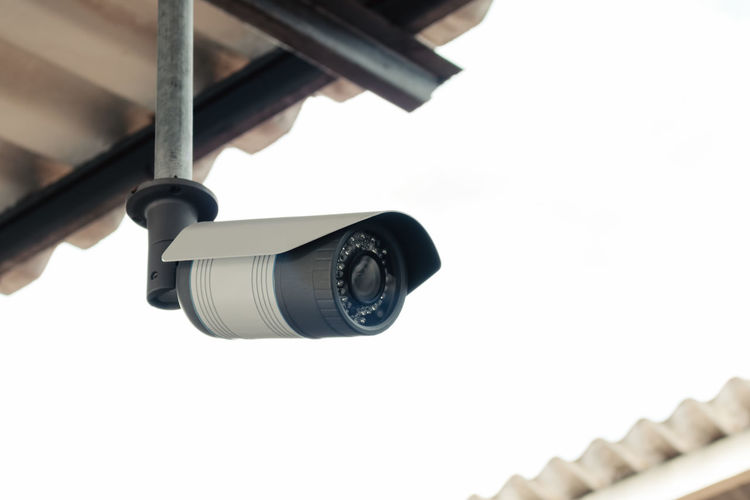 Low angle view of security camera against clear sky
