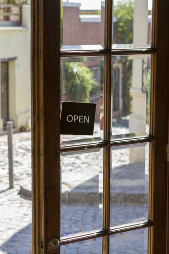 Close-up of open close text on glass window