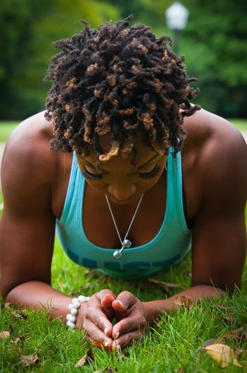 Close-up of woman exercising on field