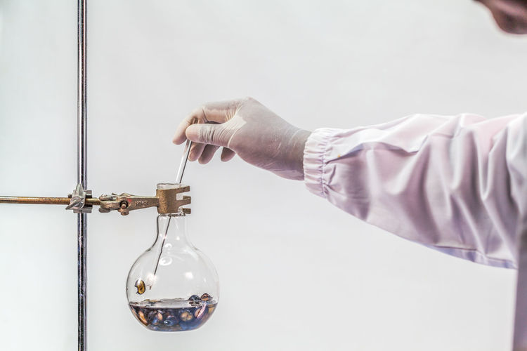 Cropped hand of scientist analyzing chemical in laboratory