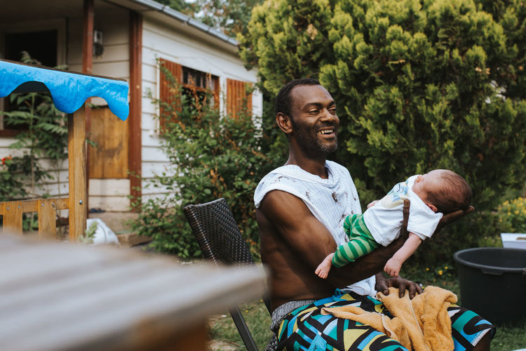 joyful and proud black man holding his baby boy Baby Emotions Family Fatherhood Moments Love Proud Relationship Black Caring Child Emotional Father Father & Son Fatherhood Holding Joy Lifestyles Newborn Outdoors Pride Protection Safety Smile Son Summer 50 Ways Of Seeing: Gratitude