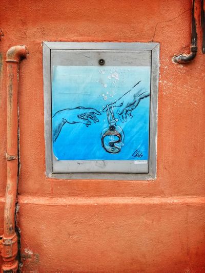 Close-up of graffiti on blue wall