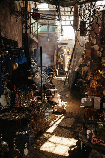 Narrow passage in typical marketplace with various colorful goods on street of old city marrakesh in morocco