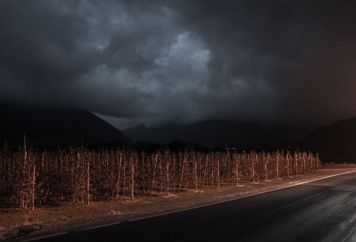 SCENIC VIEW OF ROAD AGAINST STORM CLOUDS
