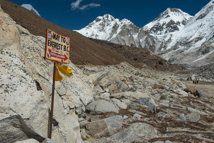 Signpost to the mount everest base camp with nuptse mountain in the background, nepal