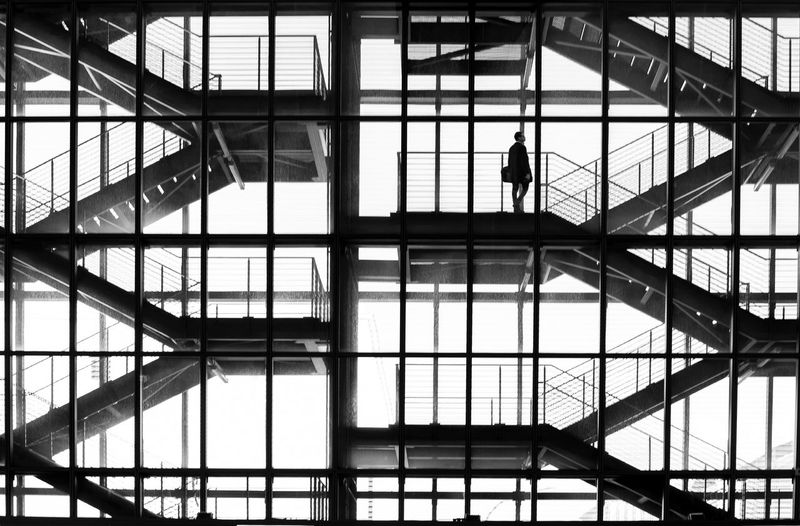 Low angle view of silhouette people walking in modern building