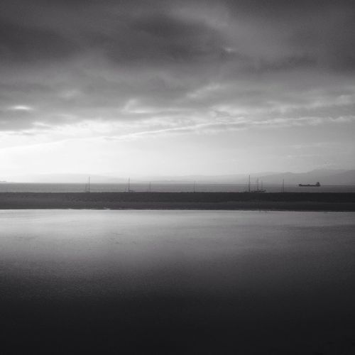 Scenic view of sea against cloudy sky