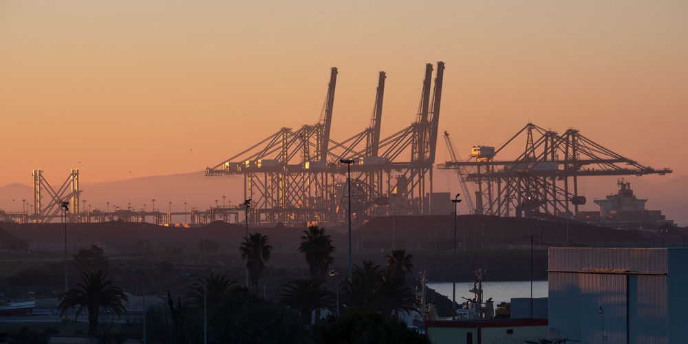 Sines container port terminal with cranes at sunset, in portugal