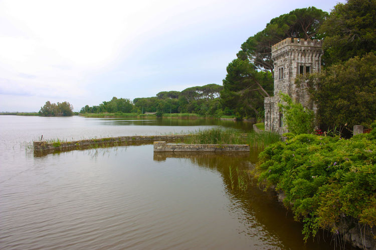 The turret of villa orlando on the lake massaciuccoli with water e vegetation