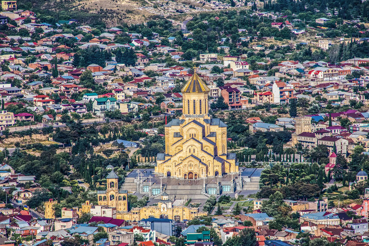 Aerial view of church amidst buildings in city 