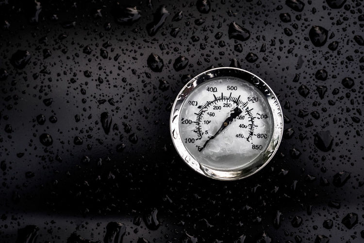 Gauge on wet glass during rainy season