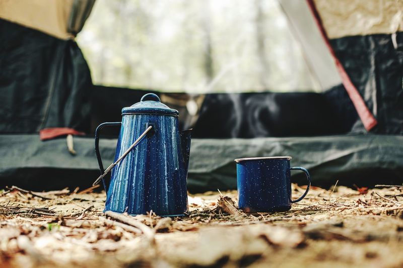 Kettle and cup in front of tent photo