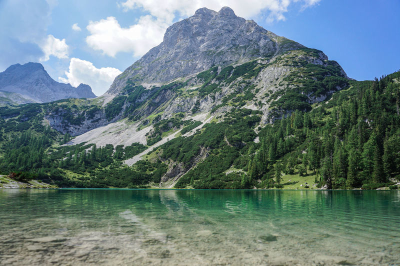 Scenic view of seebensee lake and mountains against sky