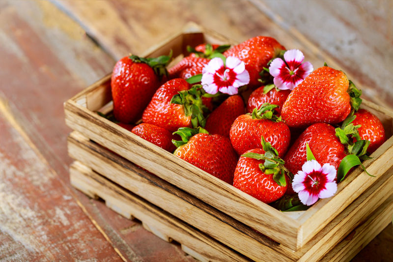 High angle view of strawberries in basket on table