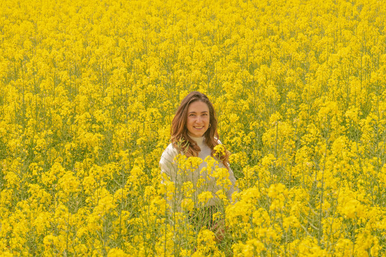 Close-up of yellow flowering plants on field