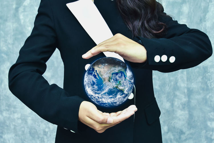 Digital composite image of woman protecting earth