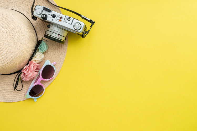 High angle view of headphones on yellow background