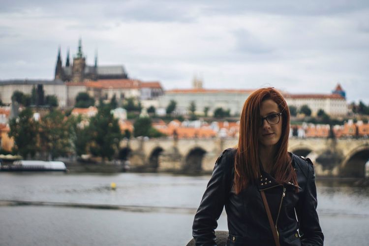 Woman posing in front of charles bridge