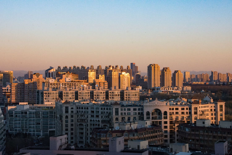 Cityscape against sky during sunrise