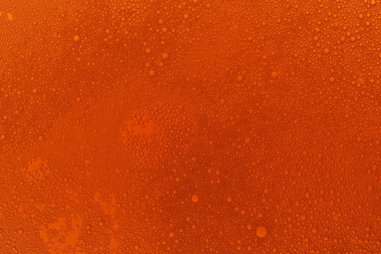 Full frame shot of wet orange surface