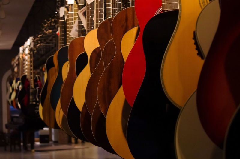 Close-up of multi colored guitars at market stall