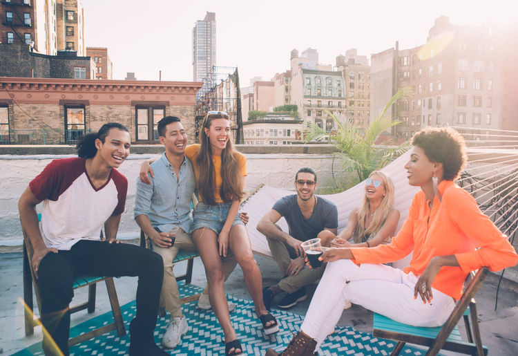Group of people sitting in front of buildings