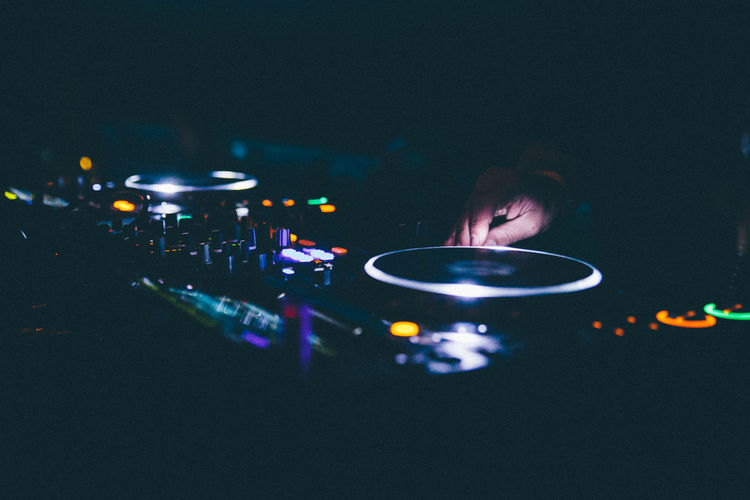 Cropped image of dj mixing sound at nightclub