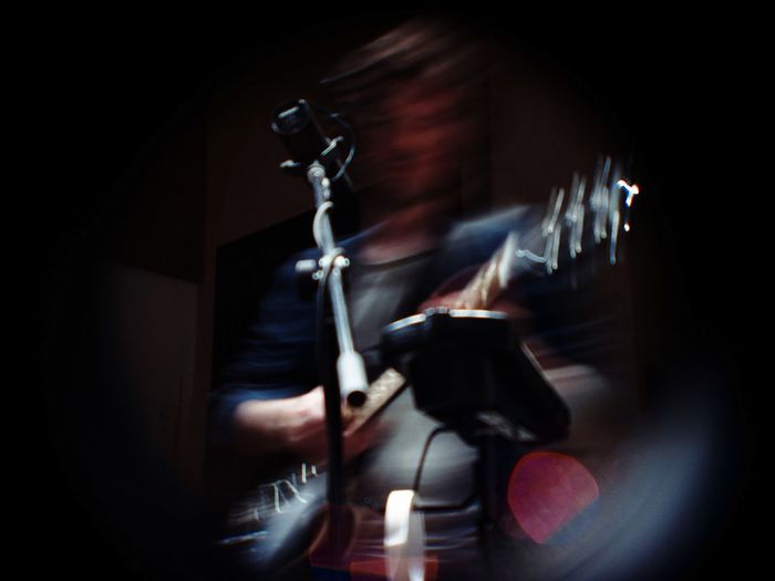 Blurred motion of man playing guitar during concert