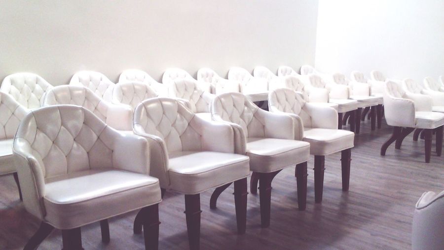 White chairs arranged on hardwood floor