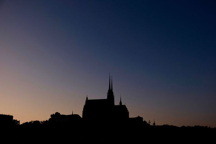 Silhouette buildings against sky during sunset