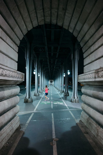 View of runner under bridge in city
