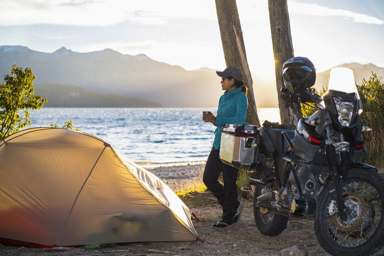 Woman relaxing at camp at the nahuel huapi lake in patagonia