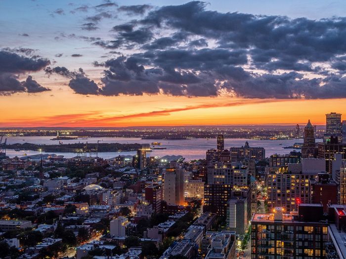 High angle view of illuminated buildings against sky during sunset