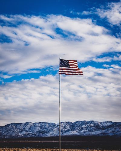Flag on field against sky