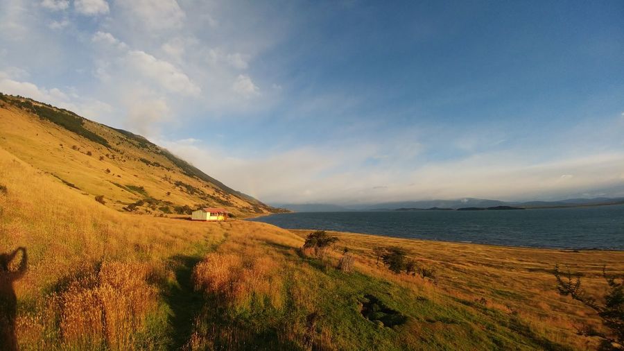 Scenic view of sea and landscape against sky