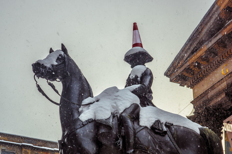 View of statue on snow covered building during winter